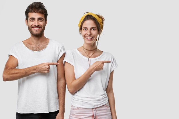 cheerful Caucasian young lady and man have pleased facial expressions