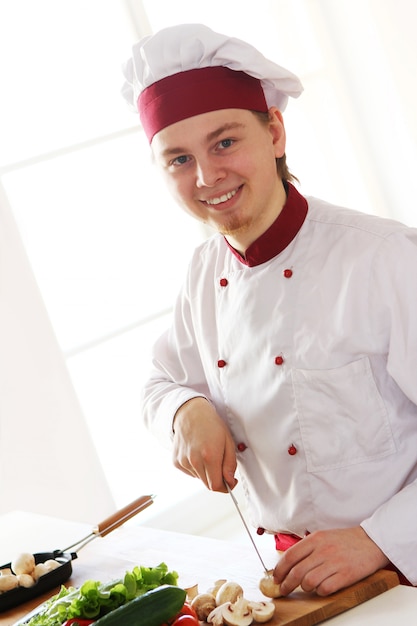 Free photo cheerful chef on the kitchen