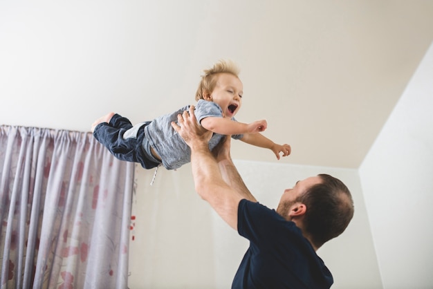 Cheerful child enjoying with his father