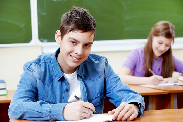 Cheerful child finishing his summary