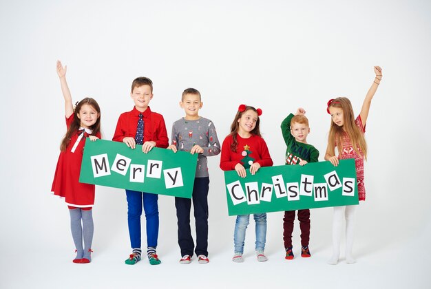 Cheerful children holding christmas decoration