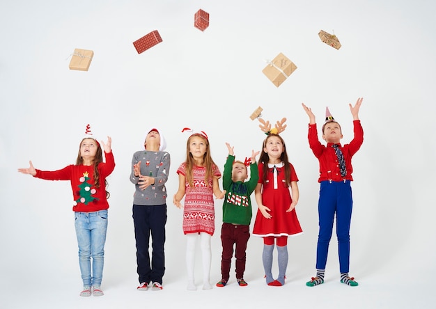 Cheerful children throwing their gift