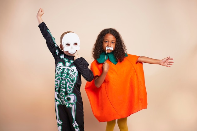 Free photo cheerful children with halloween costume