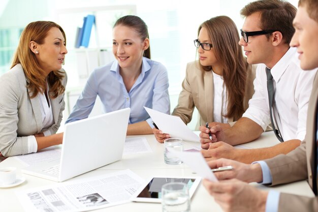 Cheerful co-workers in office during company meeting