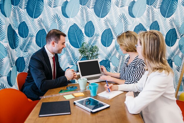 Free photo cheerful colleagues coworking in office