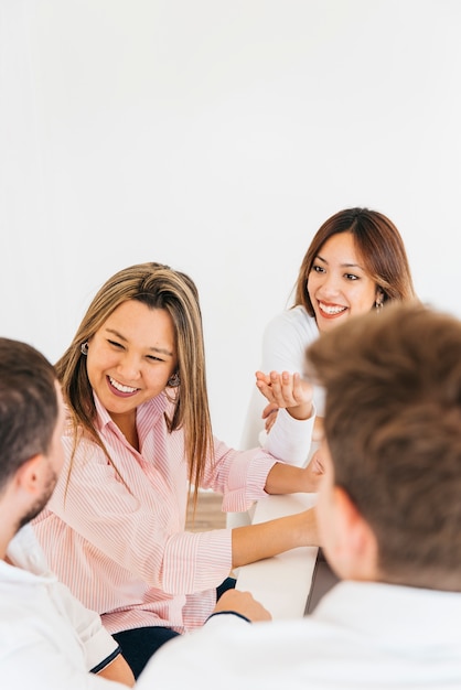 Free photo cheerful colleagues laughing in office