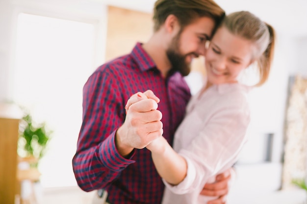 Cheerful couple dancing at home