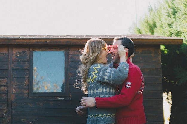 Free photo cheerful couple having fun in heart glasses