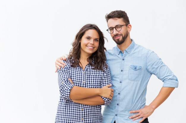 Cheerful couple hugging and posing