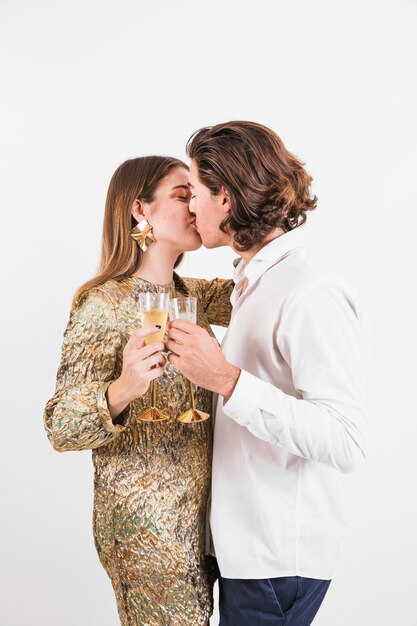 Cheerful couple kissing at birthday party