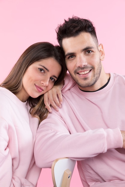 Cheerful couple leaning on back of chair