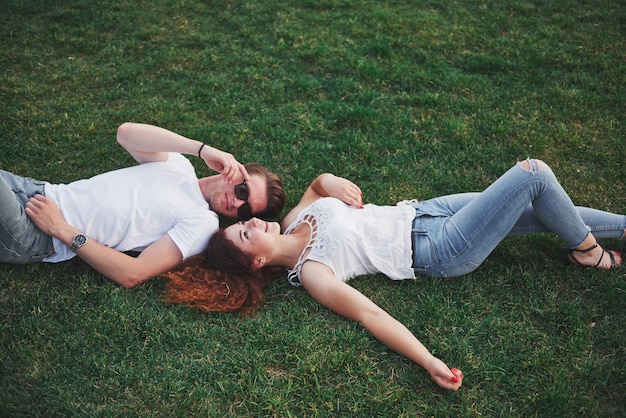 Cheerful couple lying on the grass.