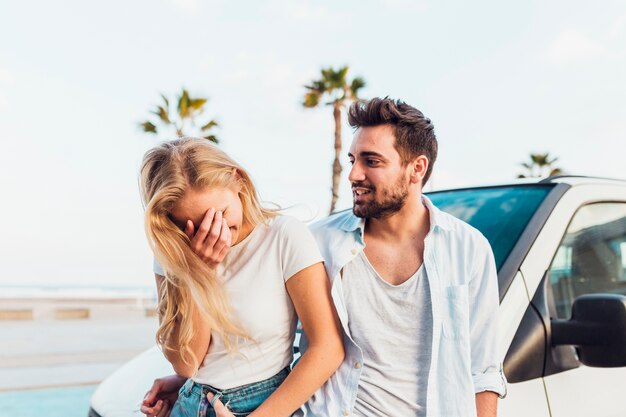 Cheerful couple near car