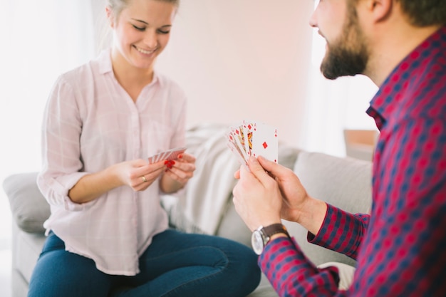 Cheerful couple playing cards