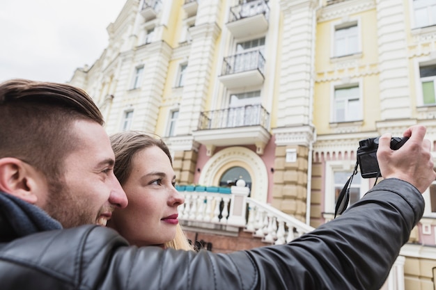 Cheerful couple sightseeing and taking shots