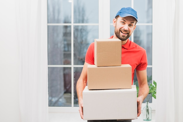 Cheerful courier with parcels