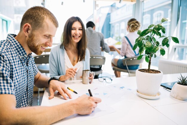 cheerful coworkers with papers
