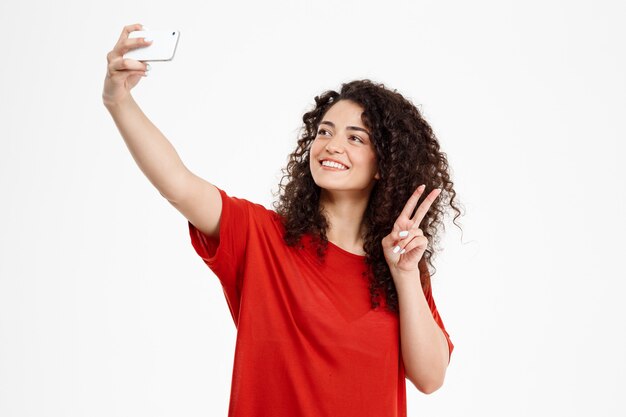  cheerful curly girl make selfie