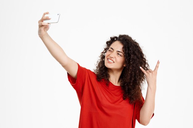  cheerful curly girl make selfie