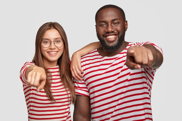 Free photo cheerful delighted best friends posing against the white wall