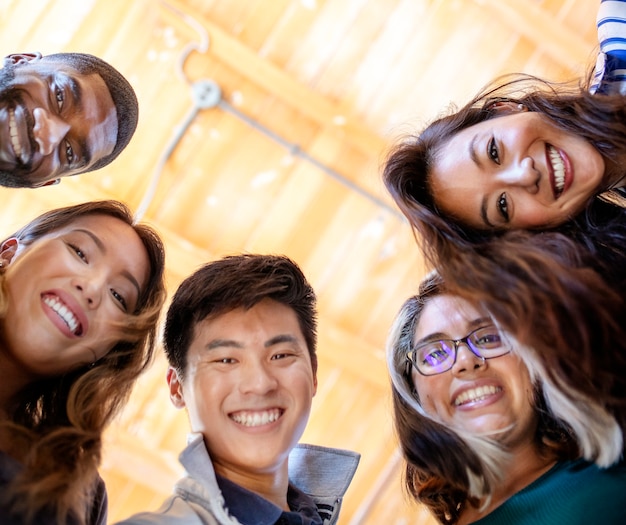 Cheerful diverse people circling together