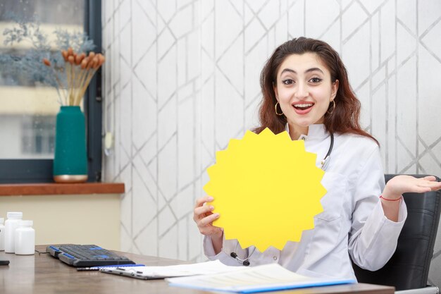 Cheerful doctor holding idea bubble and open her hand