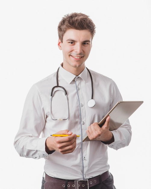 Cheerful doctor with tablet and pen