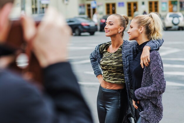 Cheerful elegant women on street