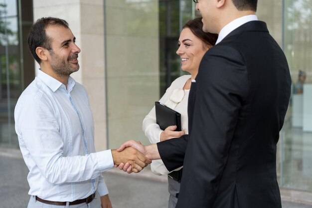 Cheerful entrepreneur greeting new business partner