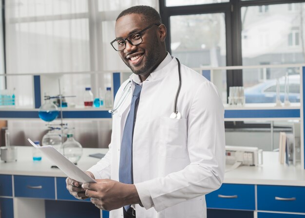 Cheerful ethnic medic with papers