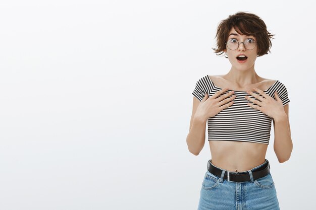 Cheerful and excited woman looking left amazed and upbeat