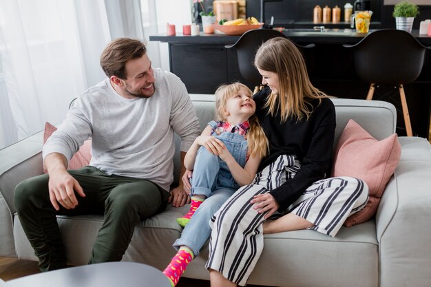 Cheerful family hugging on couch