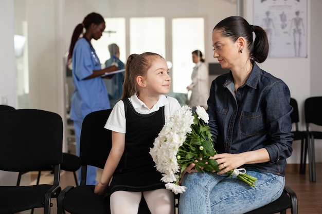 Cheerful family waiting in hospital hallway area during medical examination