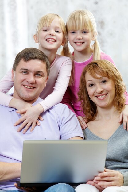 Веселая семья с ноутбуком