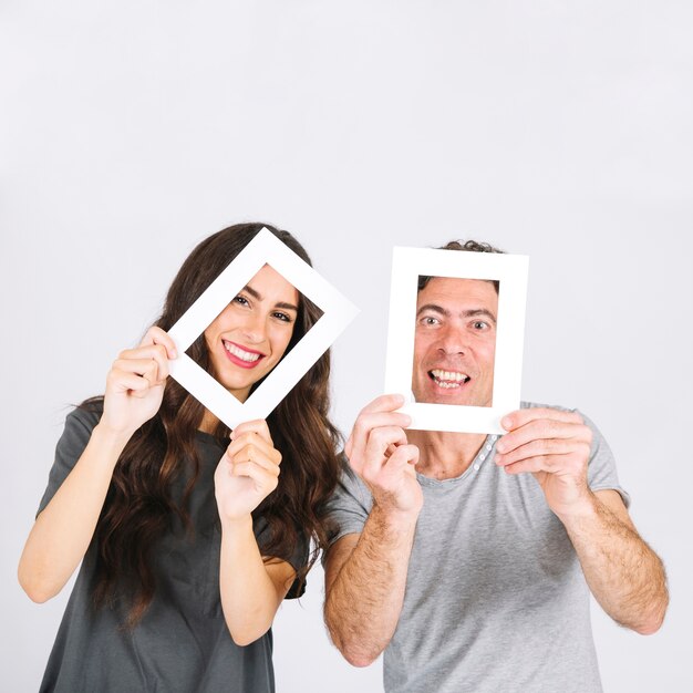 Cheerful father and daughter with frames