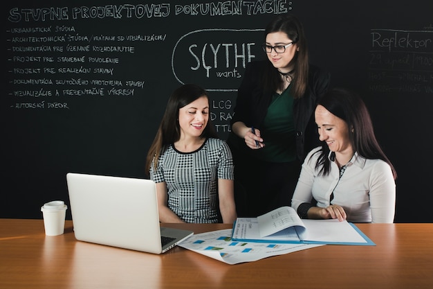 Free photo cheerful female coworkers in office