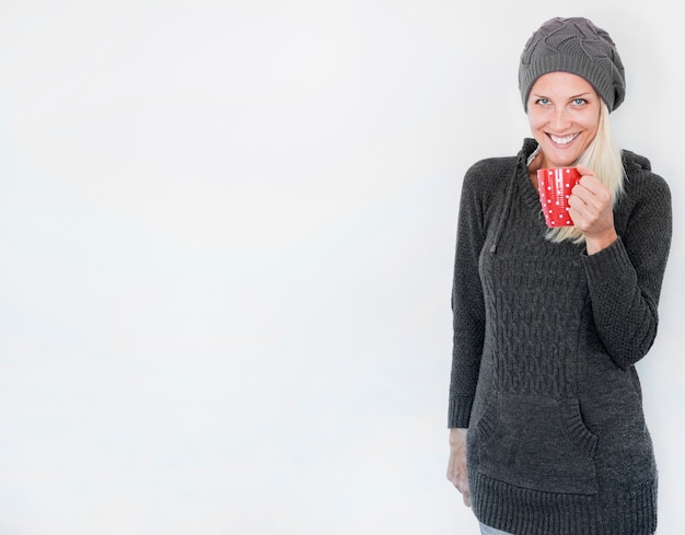 Cheerful female enjoying hot beverage