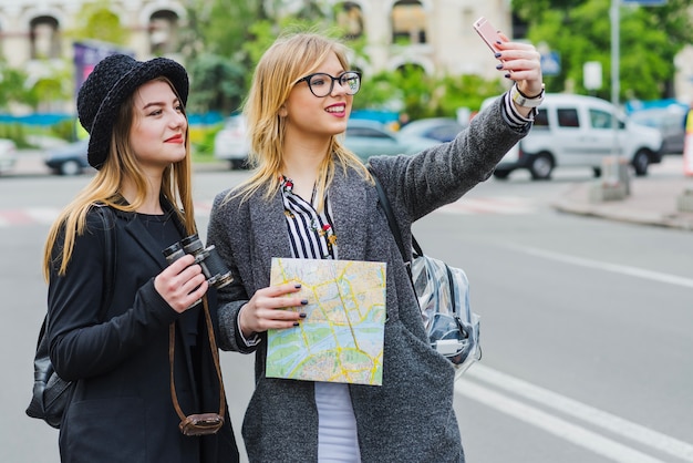 Cheerful female friends taking selfie