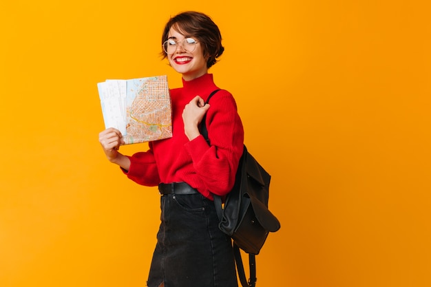 Cheerful female model holding city map