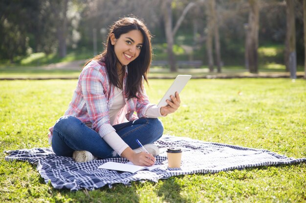 Cheerful female student working on class project