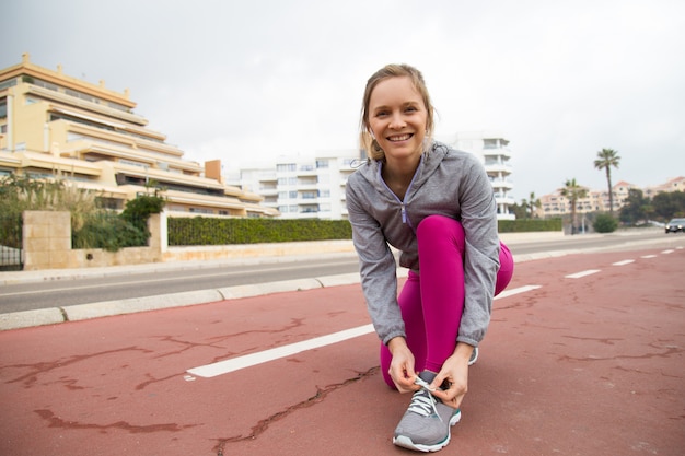 Cheerful fit girl happy to start running