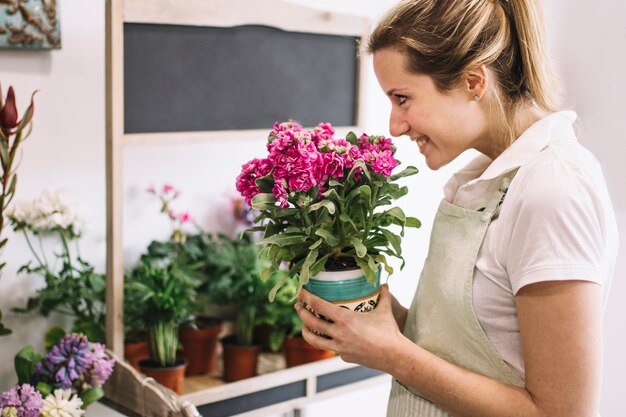 鉢植えの花を嗅ぐ陽気な花屋