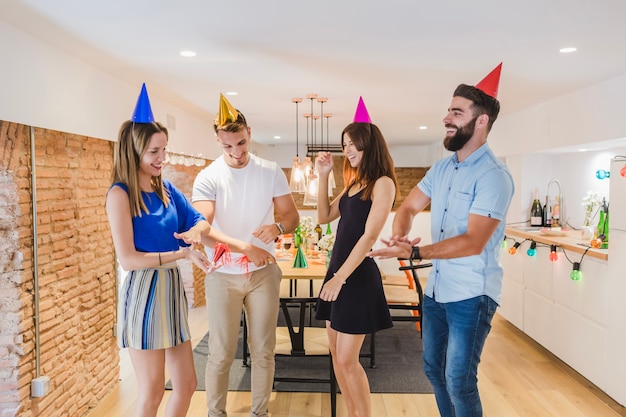 Cheerful friends dancing at party