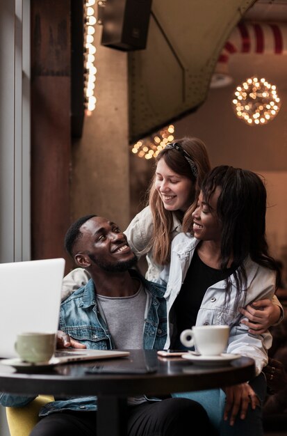 Cheerful friends laughing indoors