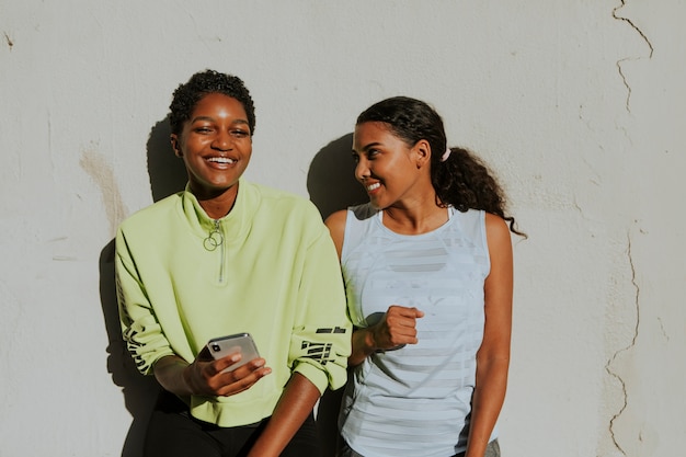 Cheerful friends looking at a phone