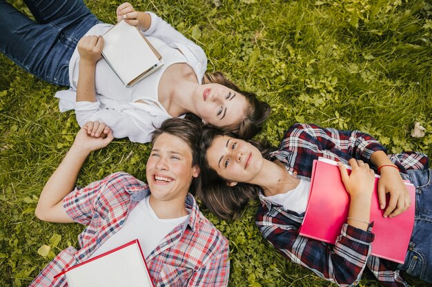 Cheerful friends posing on grass