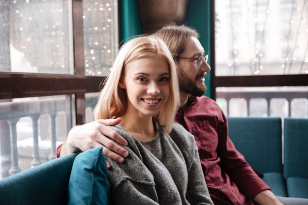 Cheerful friends sitting in cafe