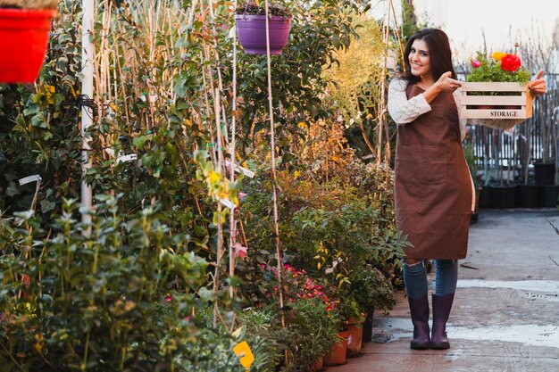 Cheerful gardener with flowers