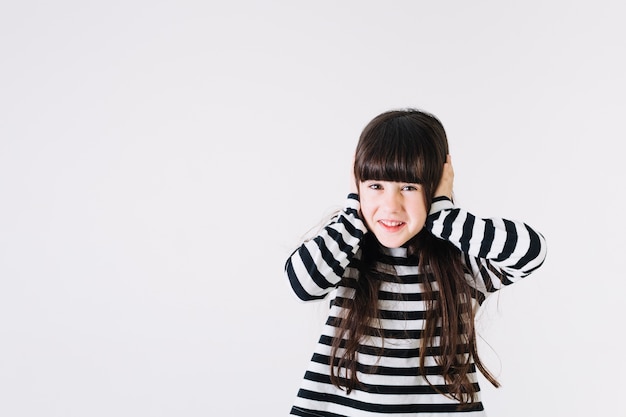 Cheerful girl covering ears