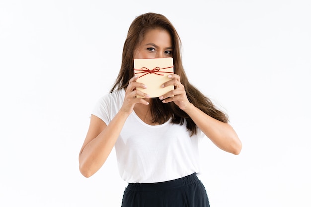 Free photo cheerful girl covering face by gift